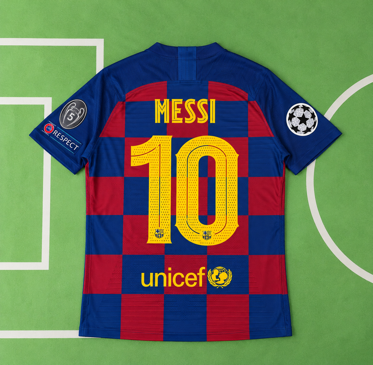 Back view of a Barcelona soccer jersey with Lionel Messi's name and number 10, laid flat on a green soccer field background. Features the club's blue and red checkered pattern, yellow lettering, and sponsor logos including UNICEF.